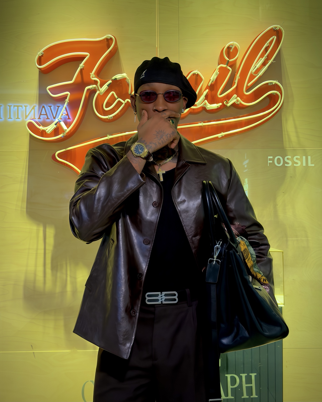 Claudio Conde en veste de cuir devant une vitrine lumineuse